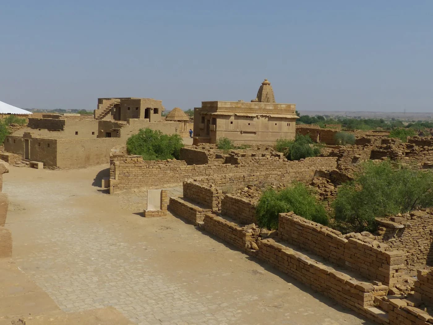 Roofless stone houses along the empty streets of Kuldhara village